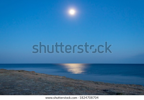 full moon over the\
sea, view from the cliff