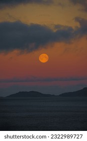 full moon over snow covered mountain landscape during dusk