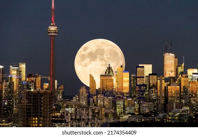Full moon over Toronto at night. Toronto night full moon. Moonshine in night Toronto. Night cityscape full moon - Shutterstock ID 2174354409