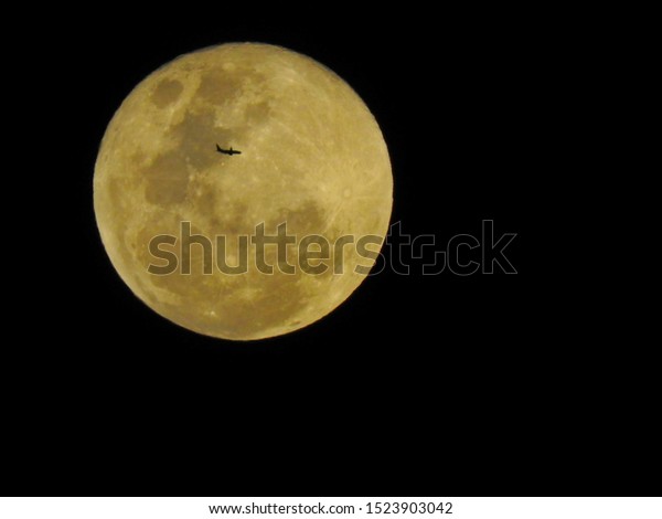  Full moon with\
plane passing in front