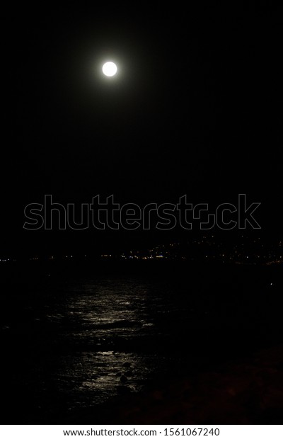 Full moon reflection
on the sea by night.
