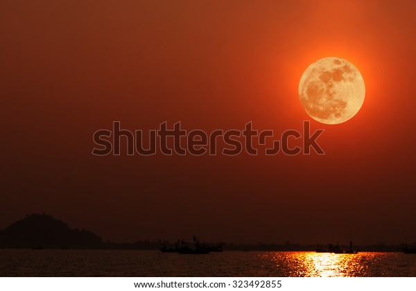 Full moon with\
reflection on sea at night