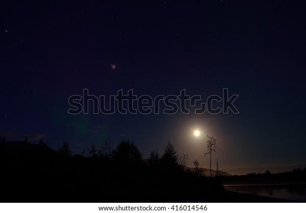 full moon river landscape at night with cold mist\
over water