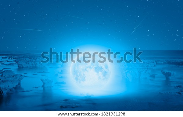 Full moon in the sea, falling
star in the background 