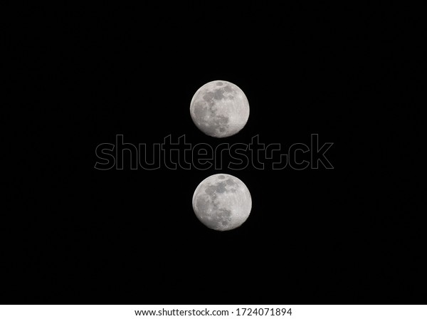 full moon. set of two moons on the background\
of a dark night of a day of May\
2020