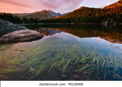 A Full Moon Sets In The Early Morning Hours Of Late Spring Over The Peaks Of Rocky Mountain National Park.  This Image Was Taken Near The Storm Pass Trail Head Above Estes Park, Colorado.