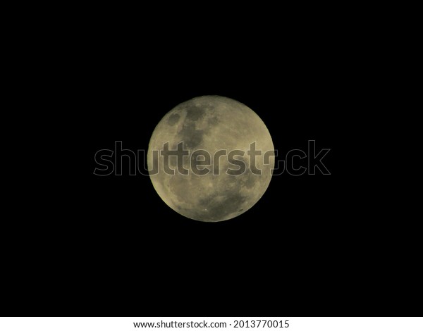 full moon shaded in green, floating\
isolated on a dark night in the southern\
hemisphere.