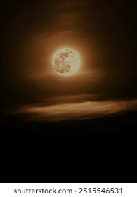 Full Moon Shining through the Clouds - This evocative photograph showcases a glowing full moon partially veiled by soft, ethereal clouds, creating a mesmerizing and mysterious atmosphere.