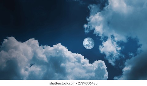 Full moon shining through clouds in the night sky.Mystic bright full moon scenery with fluffy dark cloudscape.