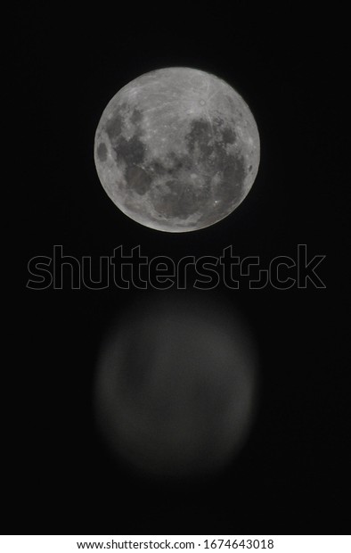 full moon shot with the\
reflection