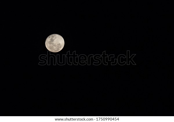 Full moon in the sky with\
black background. Sight in Brazil. May arise in clear skies due to\
pandemic