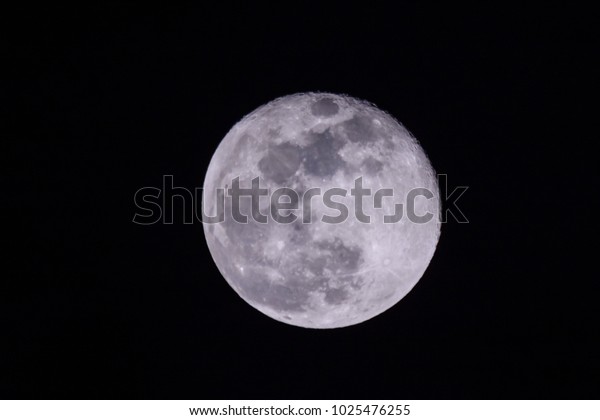 Full moon in sky at night.\
Closeup