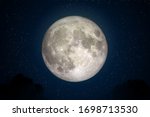 Full Moon in space with dark cloud in night sky. (Elements of this image furnished by NASA.)