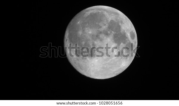 Full\
moon stack dark night sky. The full moon is lunar phase when It\
appears fully illuminated from Earth\'s\
perspective