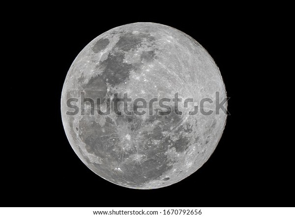 Full moon stack dark night sky. The full moon is\
lunar phase when It appears fully illuminated from Earth\'s\
perspective. It occurs when Earth is located between Sun and Moon\
appears as a circular disk