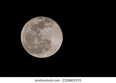 Full Moon whit the visible surface crater in the black dark night background
