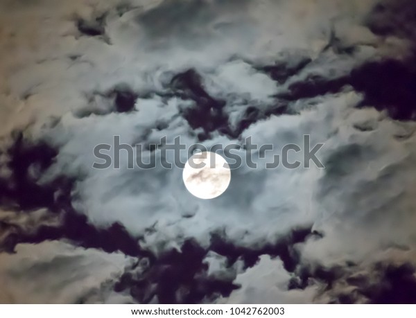 Full moon and white cloudy sky background
in the midnight, look fresh and beautiful.
