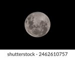 Full Moon Worm Moon rising in the clear night sky as a penumbral lunar eclipse ends at Woy Woy on the Central Coast, NSW, Australia. A 12 image HDR merge.