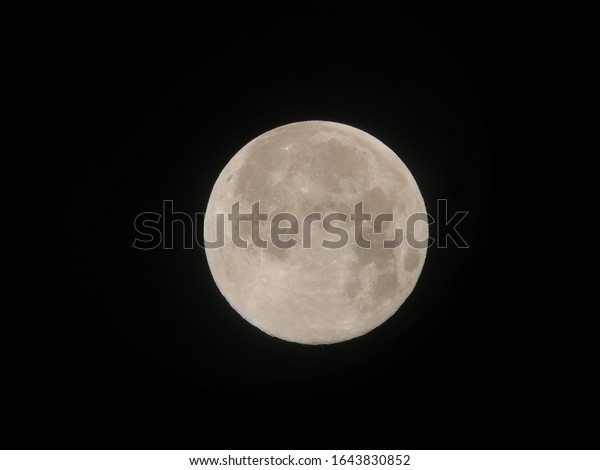 Full moon,view from Refractor telescope and\
seen in the Eastern Asian hermisphere Thailand. Full moon phase\
occurs when the Moon is on the opposite side of the Earth from the\
Sun, called opposition.