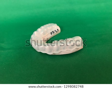 Full mouth plaster model of an asian woman for night guard making (occlusal splint) isolated on green background
