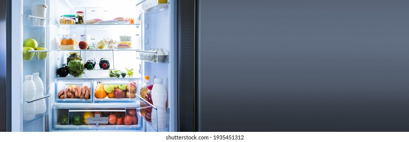 Full Open Refrigerator Or Fridge At Night In Kitchen