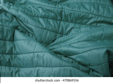 A Full Page Close Up Of Quilted Turquoise Sleeping Bag Fabric Texture