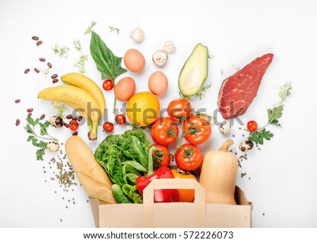 Full paper bag of different health food on a white background. Top view. Flat lay