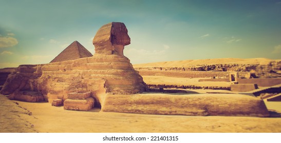 The full profile of the Great Sphinx with the pyramid  in the background in Giza. Egypt. Filtered image:cross processed lomo effect. 