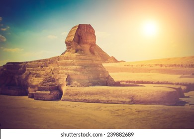 The full profile of the Great Sphinx with the pyramid in the background in Giza. Fantastic morning glowing by sunlight. Filtered image:cross processed lomo effect. 