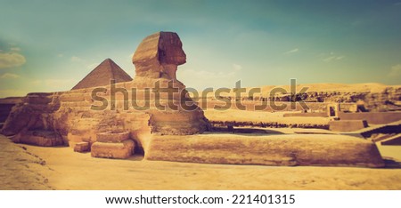 The full profile of the Great Sphinx with the pyramid  in the background in Giza. Egypt. Filtered image:cross processed lomo effect. 