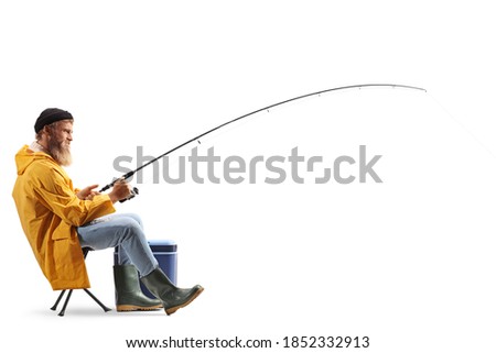 Full profile length shot of a fisherman on a chair pulling a fishing rod isolated on white background