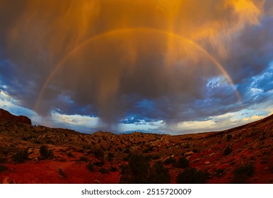 Full Rainbow with Storm Clouds over the Arches National Park in Moab, Grand County, Utah, USA: A beautiful dramatic vibrant summer sunrise wilderness landscape in the rain - Powered by Shutterstock