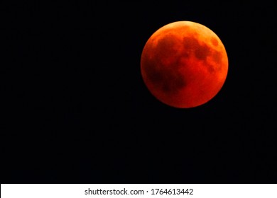 Full Red Moon By Night. Total Lunar Eclipse With Moon Turning Red Cause Of Closer Mars Planet. Astronomical Background. Copy Space.