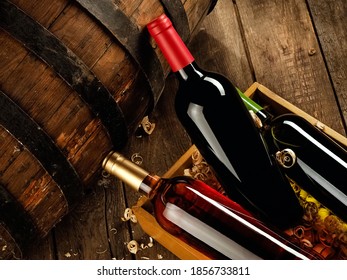 Full Red, Rose And White Wine Bottles In A Wooden Box And A Wine Keg, Top View