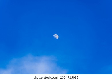Full rising moon in clear blue sky and small clouds   small swallows  natural lunar landscape  liminal space photography  space theme  Space art  Beautiful blue sky background and moon