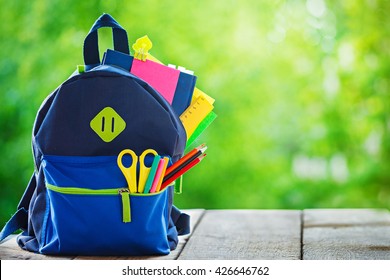 Full School backpack on wooden and nature background - Powered by Shutterstock