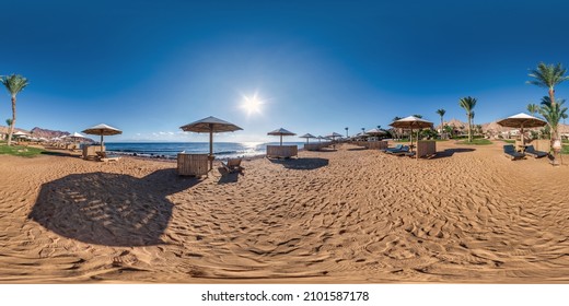full seamless spherical hdr 360 panorama view on coast of sea with wooden beach umbrellas and sun loungers by red sea in bright sunny day in equirectangular projection, ready for VR AR virtual reality
