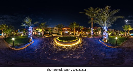 Full Seamless Spherical Night Hdr 360 Panorama On Territory Of Elite Hotel With Palm Trees And Neon  Lights In Desert On Shores Of  Red Sea In Equirectangular Projection. VR Concept