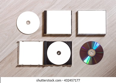 Full Set Compact Disc Template With Plastic Box Case With White Isolated Blank For Branding Design And Open Box With Booklet And Back Side. CD Jewel Case Mock Up With Free Space On Wooden Table.