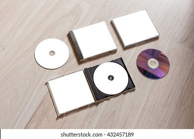 Full Set Compact Disc Template With Plastic Box Case With White Isolated Blank For Branding Design And Open Box With Booklet And Back Side. CD Jewel Case Mock Up With Clean Free Space On Wooden Table.