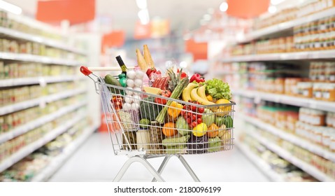 Full shopping cart with groceries inside a supermarket