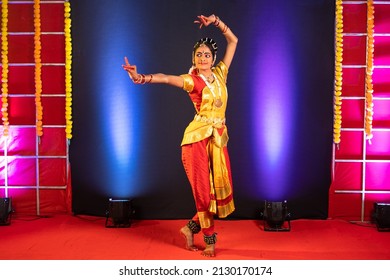 Full Shot Of Bharatnatyam Dancer Performing On Stage - Conept Of Professional Artist, Indian Traditional Dance And Culture