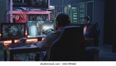 Full shot of a young man playing a first person shooter video game