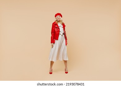 Full Size Body Length Cheerful Happy Elderly Gray-haired Blonde Woman Lady 40s Years Old Wears Red Beret Jacket Dress Looking Camera Smiling Isolated On Plain Pastel Beige Background Studio Portrait