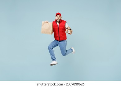 Full Size Body Length Side View Delivery Guy Employee Man In Red Cap White T-shirt Vest Uniform Work As Dealer Courier Jump Run Go Walk Isolated On Pastel Blue Color Background Studio. Service Concept