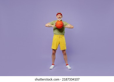 Full Size Body Length Sporty Fun Elderly Gray-haired Bearded Man 40s Years Old In Headband Khaki T-shirt Hold Basketball Ready To Play Isolated On Plain Pastel Light Purple Background Studio Portrait