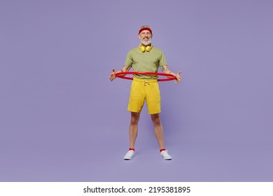 Full Size Body Length Sporty Fun Elderly Gray-haired Bearded Man 40s Years Old In Headband Khaki T-shirt Hold Exercise With Sports Hoop Isolated On Plain Pastel Light Purple Background Studio Portrait