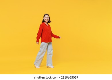 Full size body length vivid young woman of Asian ethnicity 20s years old in casual clothes look camera go move isolated on plain yellow background studio portrait. People emotions lifestyle concept - Shutterstock ID 2119665059