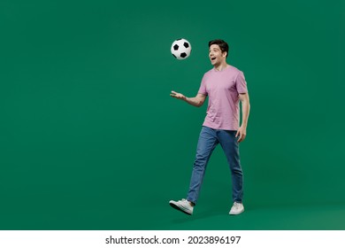 Full Size Body Length Young Fun Man Fan Wears Basic Pink T-shirt Cheer Up Support Football Sport Team Hit Hand Soccer Ball Watch Tv Live Stream Scream Go Isolated On Dark Green Color Background Studio