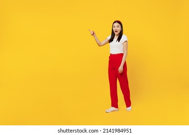 Full Size Body Length Young Girl Woman Of Asian Ethnicity 20s Years Old In Casual Clothes Go Move Point Aside On Workspace Area Copy Space Mock Up Isolated On Plain Yellow Background Studio Portrait